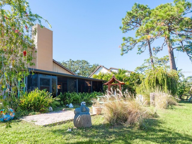 3888 Shady Brook Ln, Sarasota, FL 34243 - view of grassy yard with a sunroom