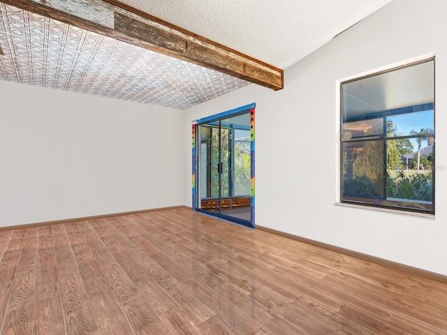 3888 Shady Brook Ln, Sarasota, FL 34243 - spare room featuring healthy amount of natural light, wood finished floors, and baseboards