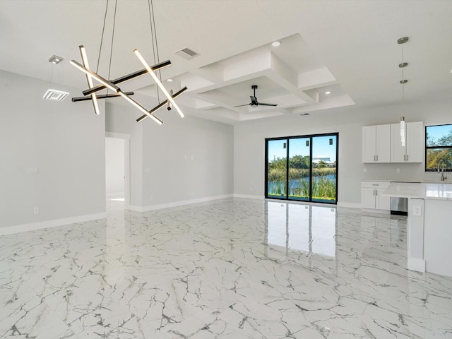 unfurnished living room featuring ceiling fan with notable chandelier, sink, and coffered ceiling