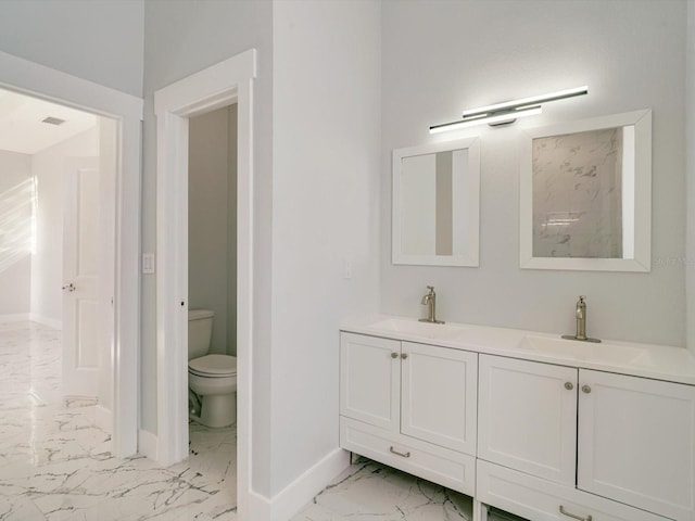 bathroom with toilet and vanity