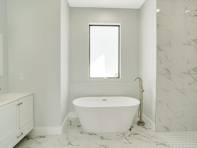 bathroom with vanity and a bath