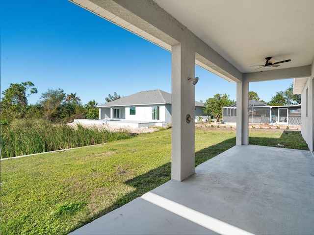 view of yard with a patio area and ceiling fan