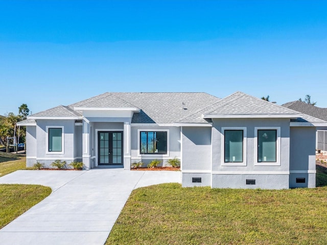 view of front of home with a front lawn and french doors