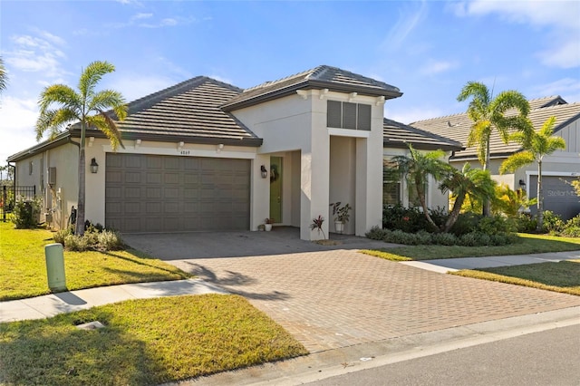 view of front of home with a garage and a front lawn