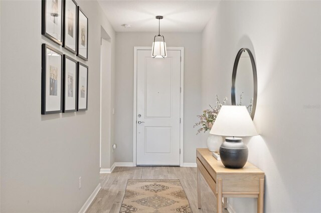 doorway with light wood-type flooring