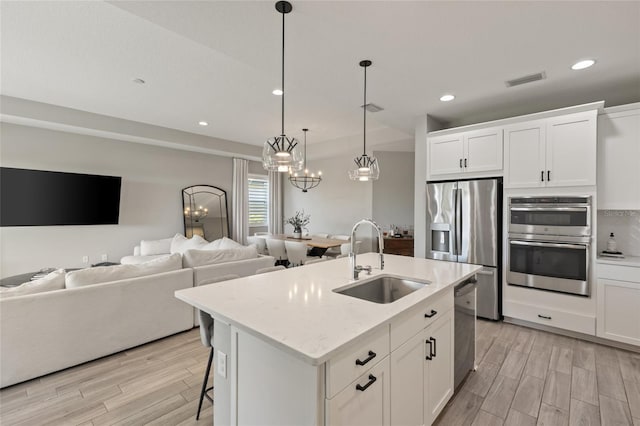 kitchen featuring white cabinetry, sink, and appliances with stainless steel finishes