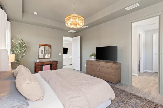 bedroom featuring wood-type flooring and a chandelier