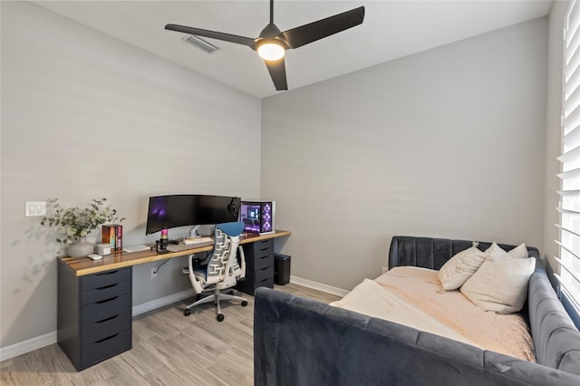 office space featuring plenty of natural light, ceiling fan, and light wood-type flooring