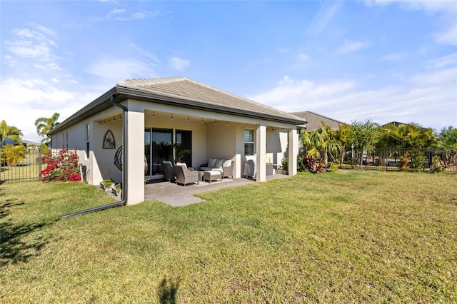 back of property with a yard, an outdoor hangout area, and a patio area