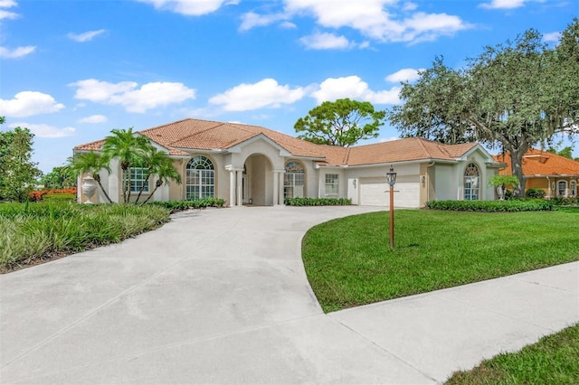 view of front of property with a front yard and a garage