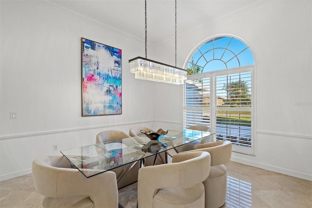 tiled dining space with a notable chandelier and ornamental molding