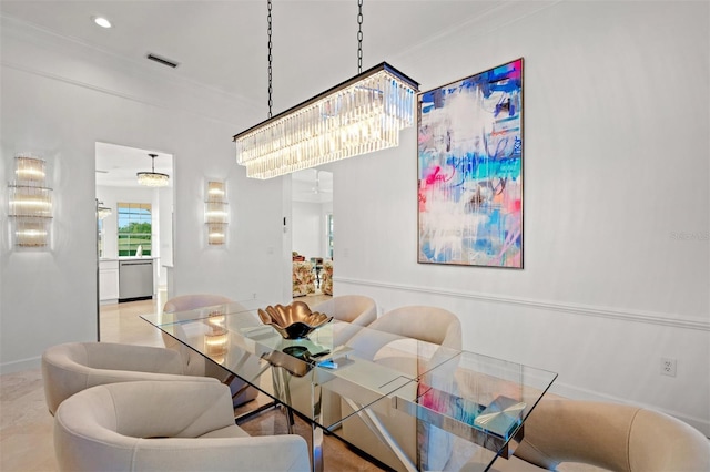 dining room featuring crown molding and an inviting chandelier