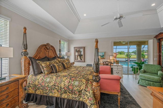 bedroom with ceiling fan, a tray ceiling, light hardwood / wood-style floors, access to outside, and ornamental molding