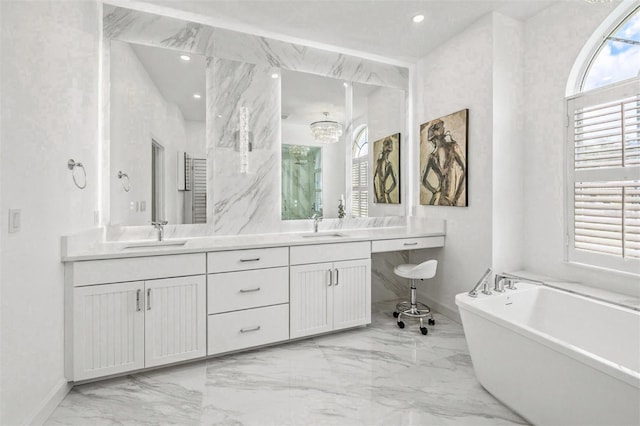 bathroom featuring a tub to relax in and vanity