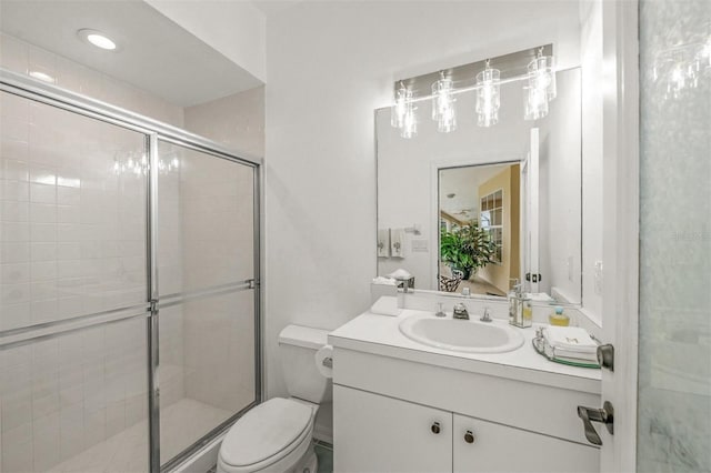 bathroom with vanity, toilet, and walk in shower