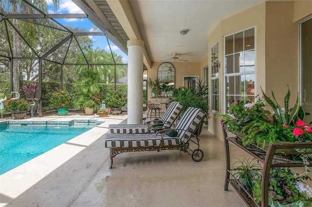 view of swimming pool with a patio, ceiling fan, and a lanai