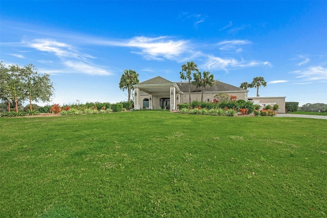 view of front of house featuring glass enclosure and a front lawn