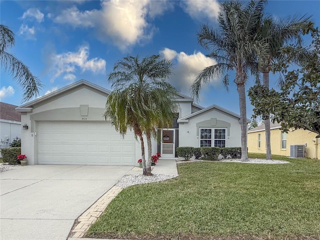 ranch-style home with a garage and a front lawn