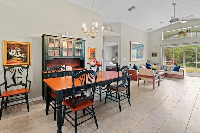 tiled dining room with ceiling fan with notable chandelier, a textured ceiling, and high vaulted ceiling