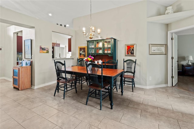 tiled dining space with a chandelier