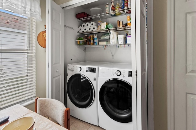 laundry room featuring light tile patterned flooring and washer and dryer