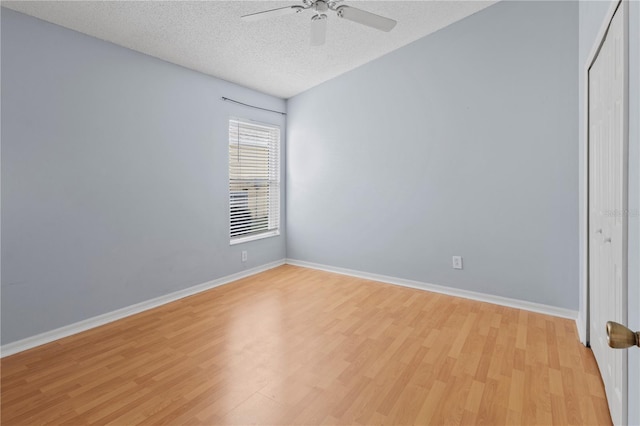 spare room with ceiling fan, a textured ceiling, and light hardwood / wood-style flooring