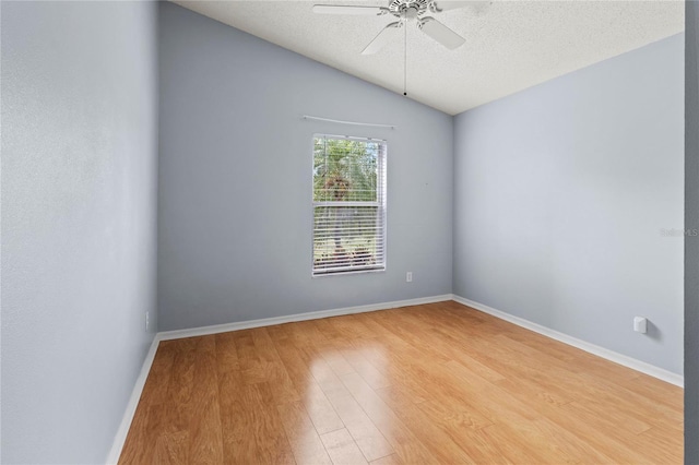 empty room featuring wood-type flooring, a textured ceiling, ceiling fan, and lofted ceiling