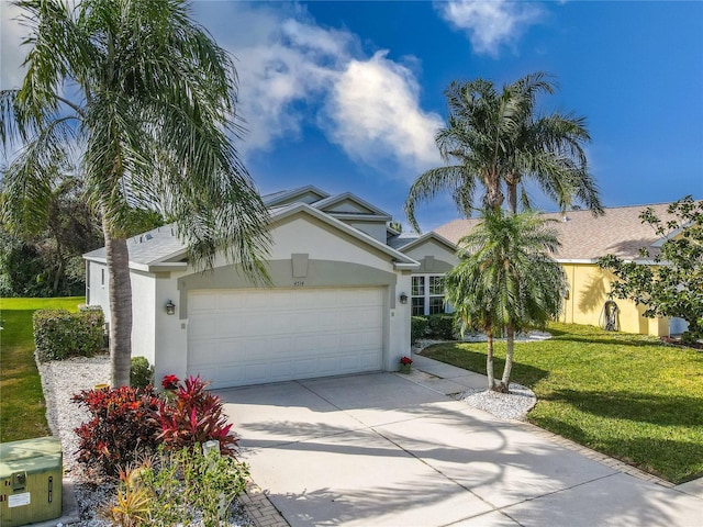 view of front of home with a front yard and a garage