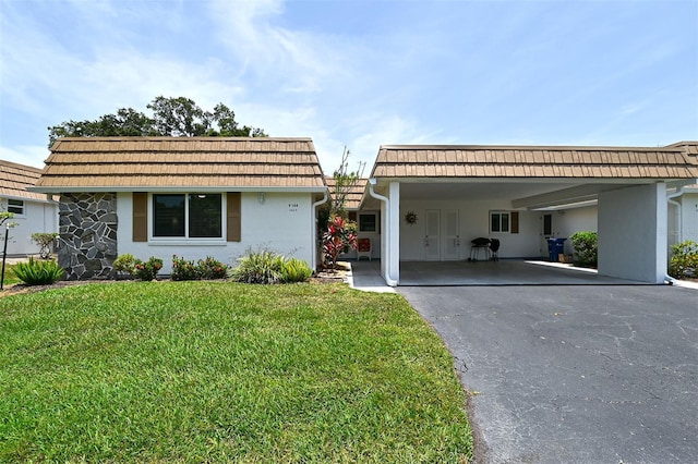 ranch-style house featuring a front yard and a carport