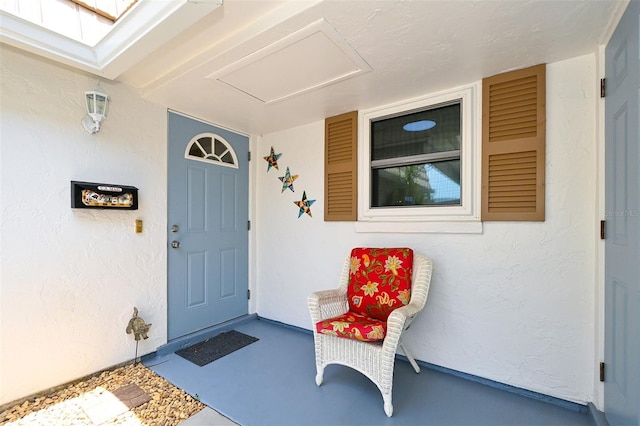 view of exterior entry featuring covered porch