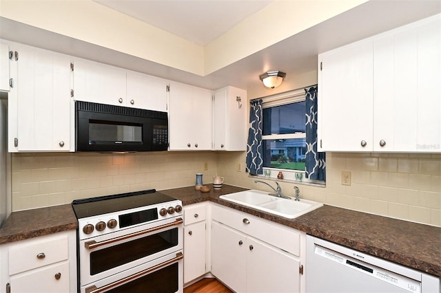 kitchen with white dishwasher, high quality stove, white cabinetry, and sink