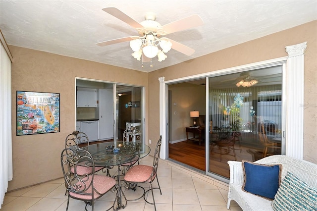 tiled dining space with ceiling fan