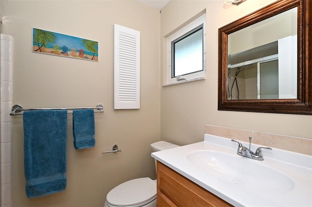 bathroom featuring walk in shower, vanity, and toilet