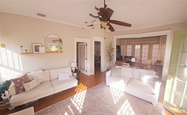 living room with ornamental molding, ceiling fan, french doors, and wood-type flooring