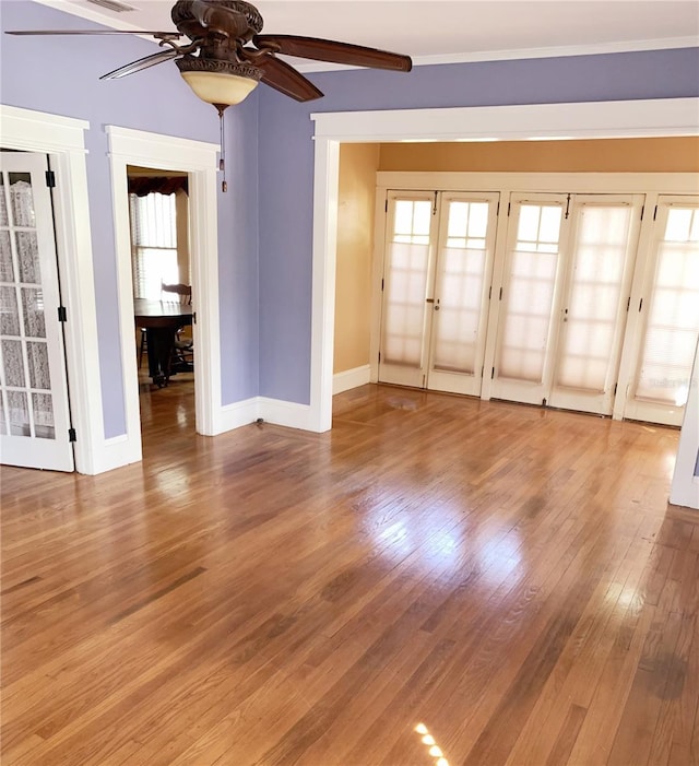 spare room with ceiling fan, french doors, and hardwood / wood-style floors