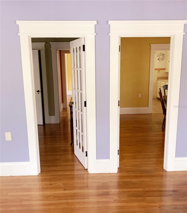 corridor with light wood-type flooring