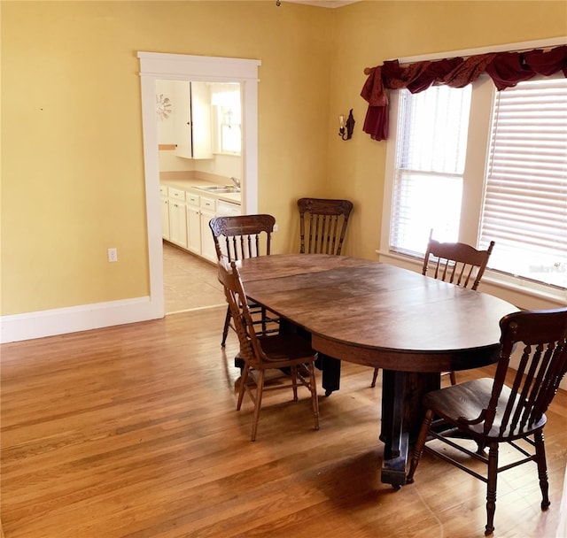 dining room with light hardwood / wood-style flooring and sink