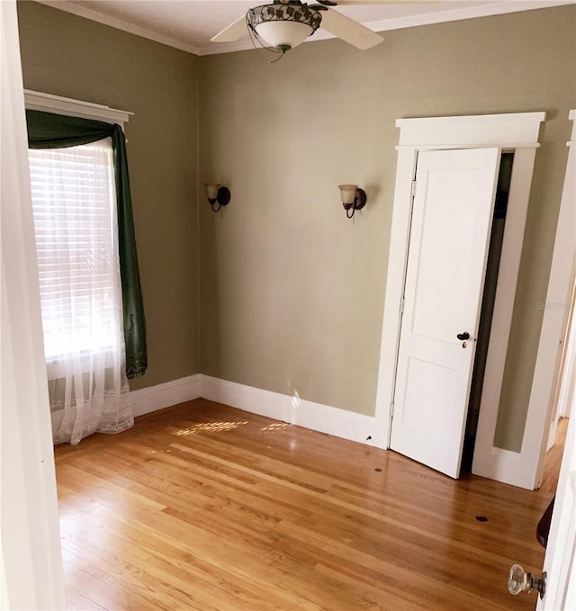 spare room featuring hardwood / wood-style flooring, ceiling fan, and plenty of natural light