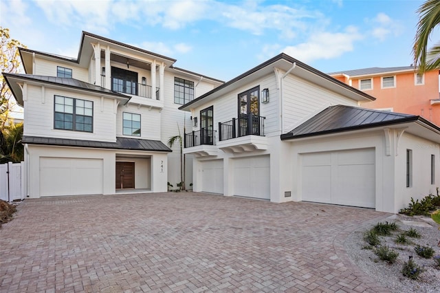 view of front of home with a garage and a balcony