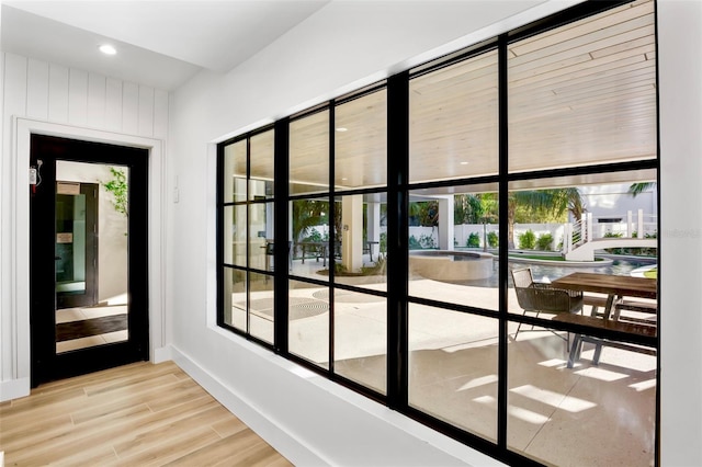 doorway to outside with light wood-type flooring