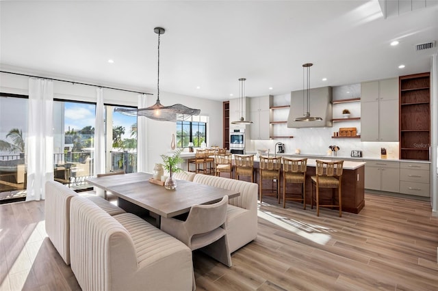 dining space featuring light wood-type flooring