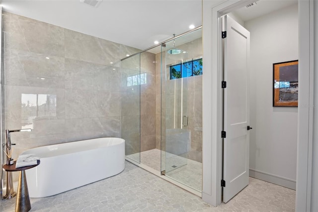 bathroom with separate shower and tub