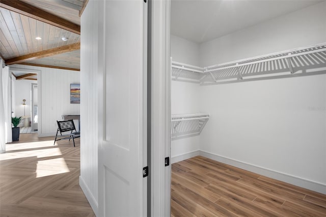 spacious closet featuring beam ceiling