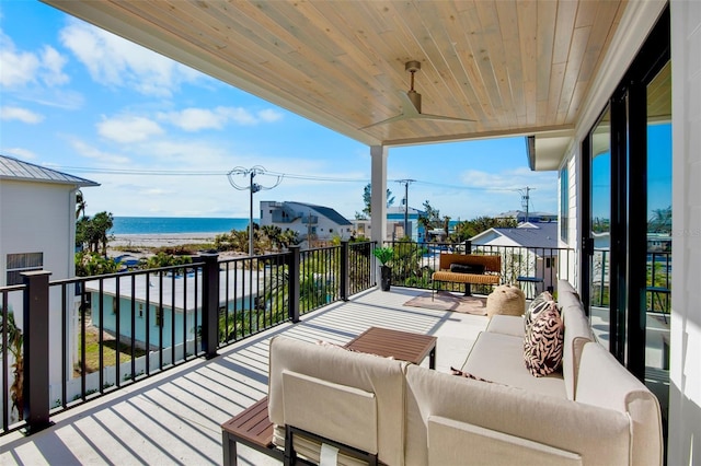 wooden terrace featuring an outdoor hangout area and a water view