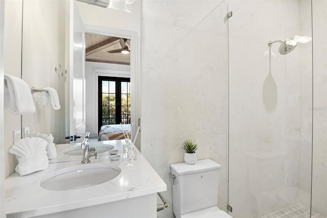 bathroom featuring french doors, vanity, toilet, and a shower with shower door