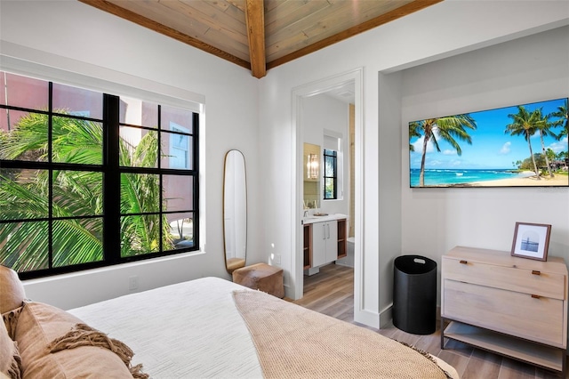 bedroom featuring ensuite bathroom, light hardwood / wood-style flooring, wooden ceiling, and vaulted ceiling