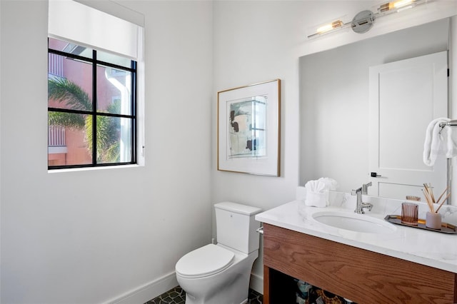 bathroom featuring tile patterned floors, vanity, toilet, and plenty of natural light