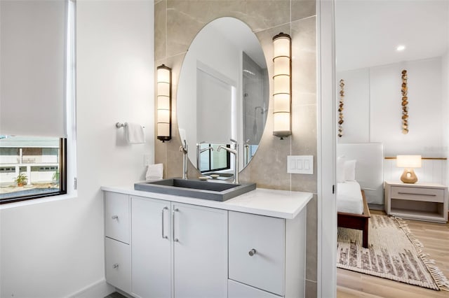 bathroom with hardwood / wood-style floors, plenty of natural light, and vanity