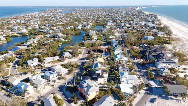 aerial view with a water view and a view of the beach