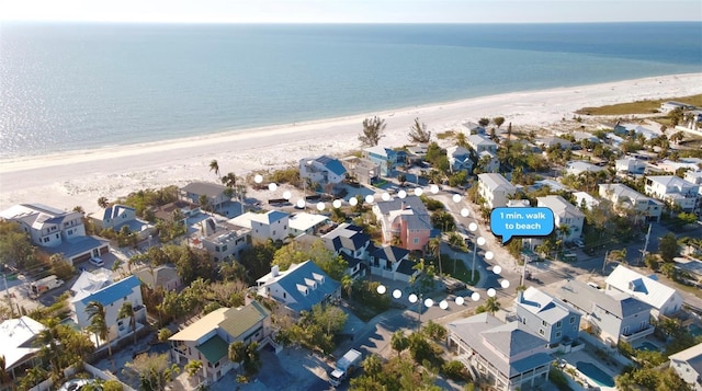 drone / aerial view featuring a water view and a beach view